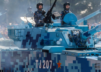 BEIJING, CHINA - SEPTEMBER 03: Chinese soldiers ride in tanks as they pass in front of Tiananmen Square and the Forbidden City during a military parade on September 3, 2015 in Beijing, China. China is marking the 70th anniversary of the end of World War II and its role in defeating Japan with a new national holiday and a military parade in Beijing. (Photo by Kevin Frayer/Getty Images)