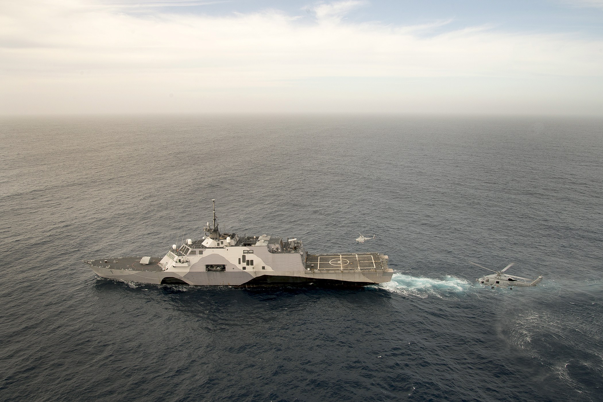 150430-N-DX365-088 PACIFIC OCEAN (April 30, 2015) An MH-60R Sea Hawk helicopter and an MQ-8B Fire Scout unmanned aerial vehicle, both assigned to Helicopter Maritime Strike Squadron (HSM) 35, conduct coordinated flight operations with the littoral combat ship USS Freedom (LCS 1) in the Southern California operating area. (U.S. Navy photo by Mass Communication Specialist 1st Class Joan E. Jennings/Released)
