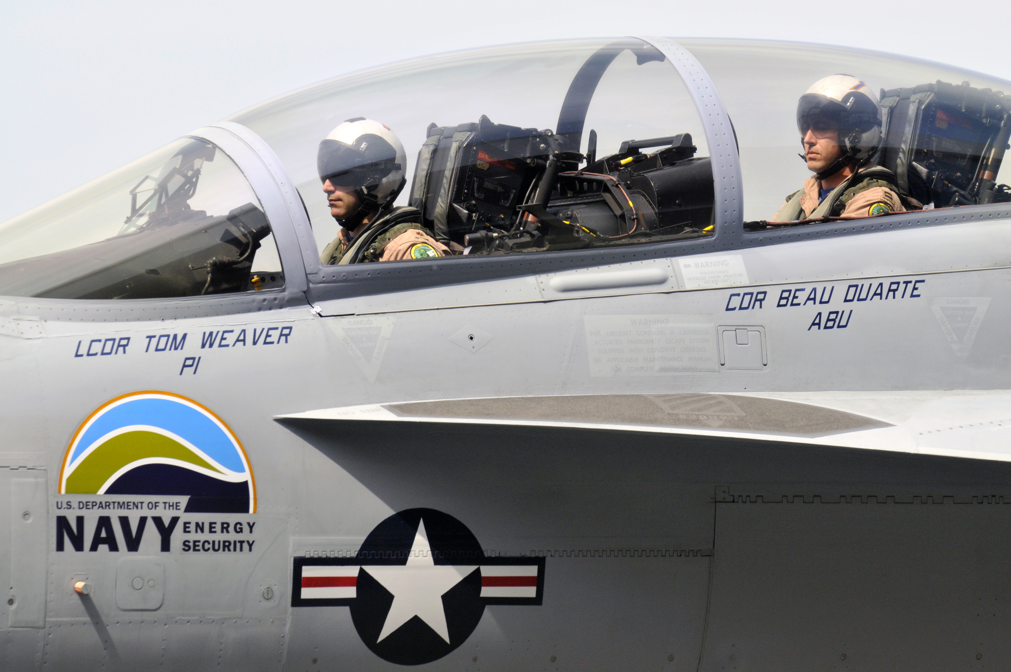 100422-N-5549O-101 PATUXENT RIVER, Md. (April 22, 2010) Navy pilots Cdr. Beau Duarte and Lcdr. Tom Weaver sit in the cockpit F/A-18 "Green Hornet" following a supersonic flight test, powered by a 50/50 blend of biofuel. The test, conducted at Naval Air Station Patuxent River, Md., drew hundreds of onlookers that included Secretary of the Navy Ray Mabus, who has made research, development, and increased use of alternative fuels a priority for the Department of the Navy. (U.S. Navy photo by Mass Communication Specialist 2nd Class Kevin S. O'Brien/Released)